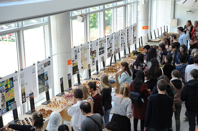 Besucher*innen des Tags der offenen Tür am Fachbereich Architektur stehen am Buffet