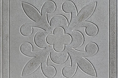 Square concrete slab with a centrally arranged floral ornament