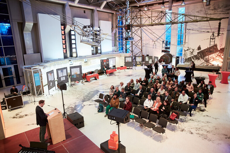 A panoramic view of the whole venue from above, with stage, poster exhibition, seating and decoration__A panoramic view of the whole venue from above, with stage, poster exhibition, seating and decoration