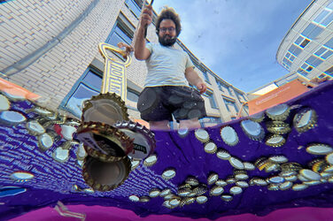 A person is fishing for bottle caps.