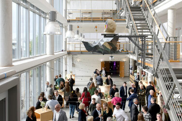 View into the foyer of the faculty with the graduates and their family and friends before the event.