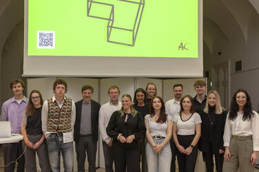 Winners of the Architects Collective Student Award for Healthcare Architecture on stage in front of a screen.