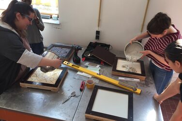 3 Students pouring the relief panels in the concrete laboratory