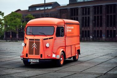 The Citroën HY stands in front of an old industrial hall on the Phönix West site in Dortmund.