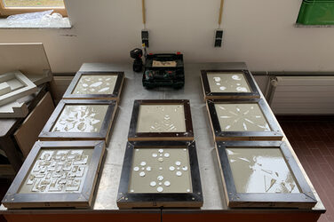 8 cast, not yet dried slabs on a table in the concrete laboratory