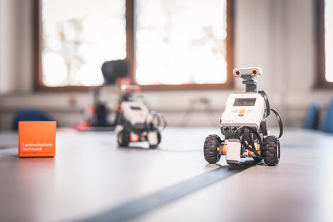 Photo of two Lego robots following the trail. __ <br>Two Lego robots follow the trail.