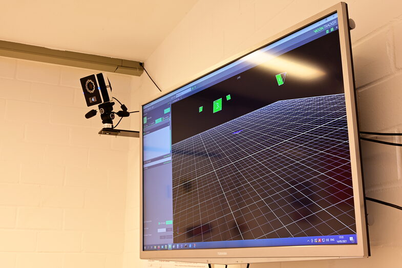 A camera on the wall and a screen showing the software of the camera system__A camera on the wall and a screen showing the software of the camera system