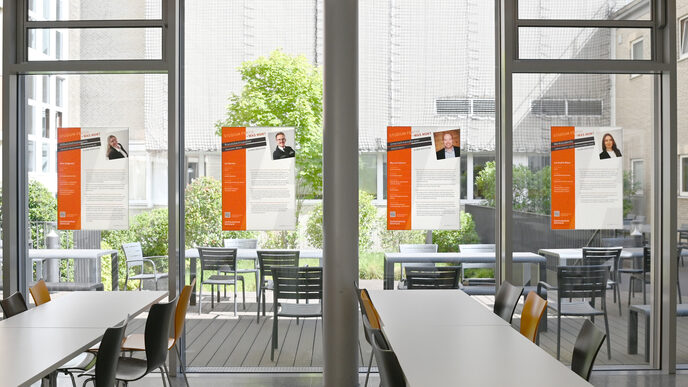 Mehrere Plakate an Fensterscheiben