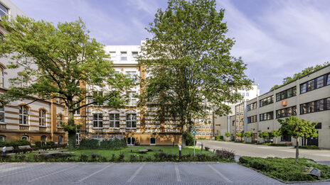 Pictures of buildings on Sonnenstrasse, parking lots in the foreground.