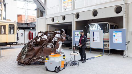 Doctoral student operates OmniMan an Omnidirectional mobile manipulator (robot).