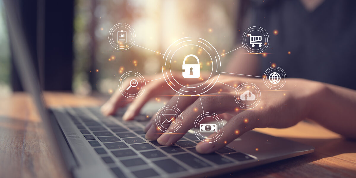 A photo of a woman working on a laptop. In the foreground you can see various symbols representing data protection.