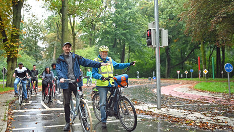 People ride bicycles