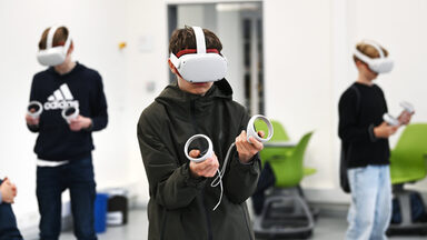 Three teenagers wear VR glasses