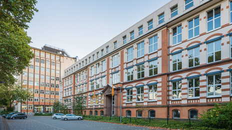 Photo of the old building and the skyscraper on Sonnenstrasse across the parking lot. __ <br>View of the old building and the skyscraper on Sonnenstrasse across the parking lot.