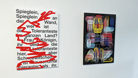 Two posters on the subject of tolerance hang on a white wall. One poster asks: "Mirror, mirror on the wall, who is the most tolerant in the whole country?"