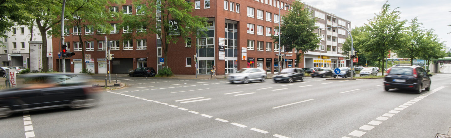 Foto eines Gebäudes an der Hohen Straße in Dortmund, davor die stark befahrene Hohe Straße.