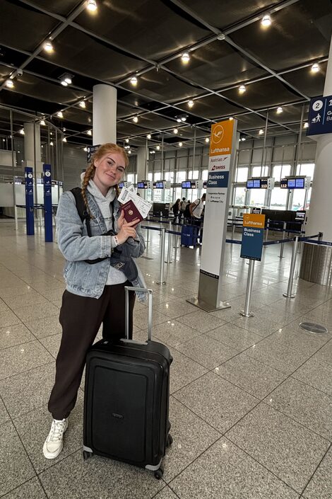 Farina Stickamp, social work student, with suitcase at the airport before departure to Denver