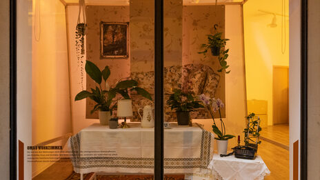 Illuminated window with artistic staging of a nostalgic living room.